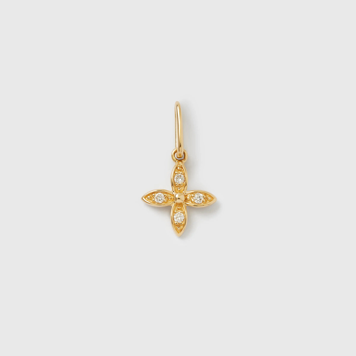Goldener Kettenanhänger in Blumenform aus Echtgold mit funkelnden, gefassten Diamanten vor hellem Hintergrund.